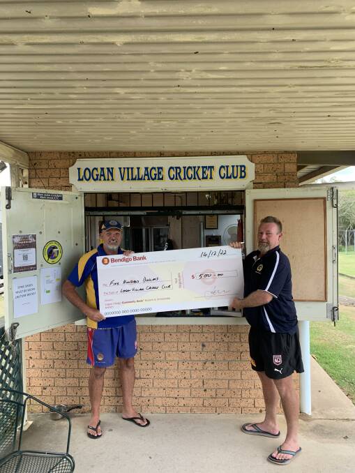 Logan Village Lions Club president Phil Notaro presents Logan Village Cricket Club president Rick Galloway with money to help outfit junior players. Picture supplied