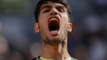 Carlos Alcaraz emits a victory roar after fighting his way past Jan-Lennard Struff in Madrid. (AP PHOTO)