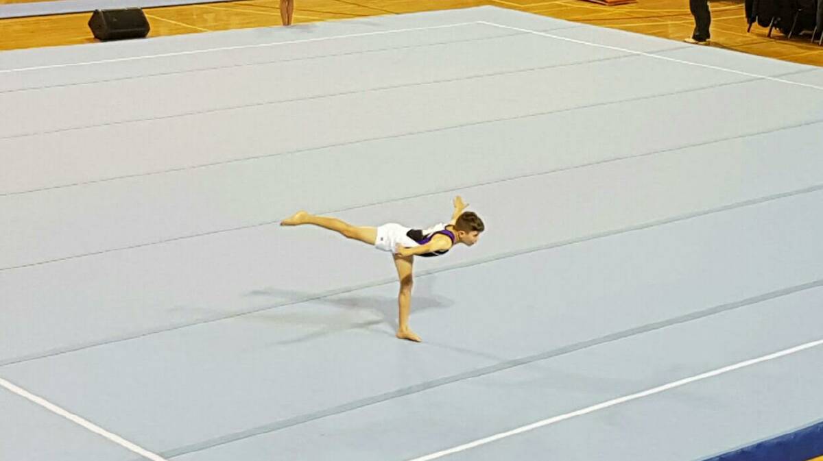 
Dylan Parker, 9, holding arabesque in his floor routine.