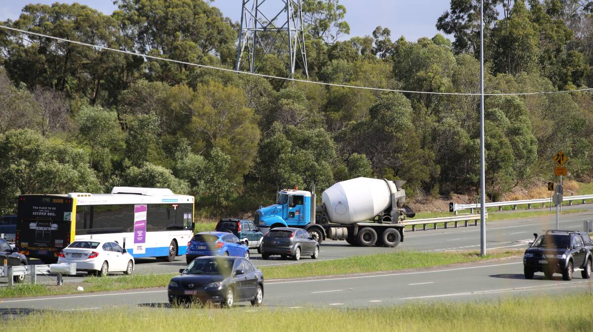 Giving way: Traffic stops to allow a cement mixer across the Mount Lindesay Highway at the Logan Motorway interchange. Photo: Stan and Suz Corbett