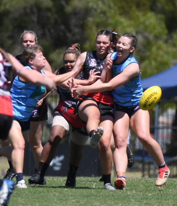 Under pressure: Jasmine Fretwell, centre, in action in the grand final. It was a hard fought, physical win for the Jimboomba players in the decider at Bond University. Photos: Matt McLennan 