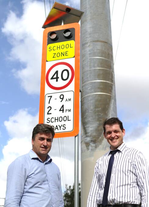 SIGNS: Member for Logan Linus Power and Browns Plains State School principal Andrew Beattie. Photo: Supplied