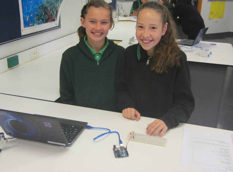 Shakayla-Jai and Chloe demonstrating Arduino. Photo: Supplied